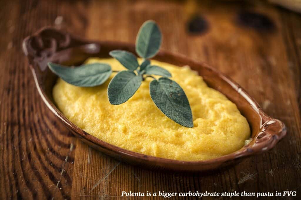 Dish of polenta topped with basil - culinary guide to Friuli Venezia Giulia