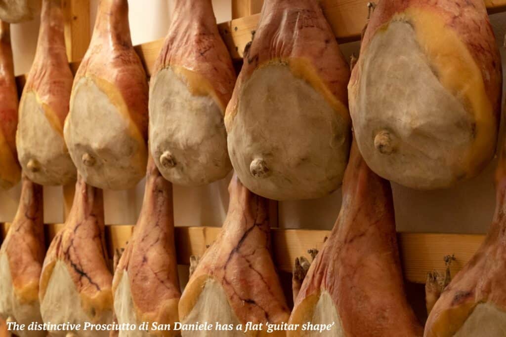 Prosciutto di San Daniele hanging from the ceiling - culinary guide to Friuli Venezia Giulia