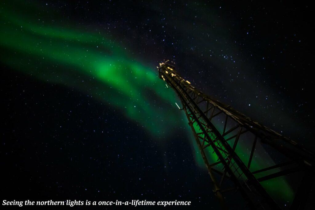 Aurora Borealis shine above a communications tower near Nuuk in Greenland - northern lights in Greenland