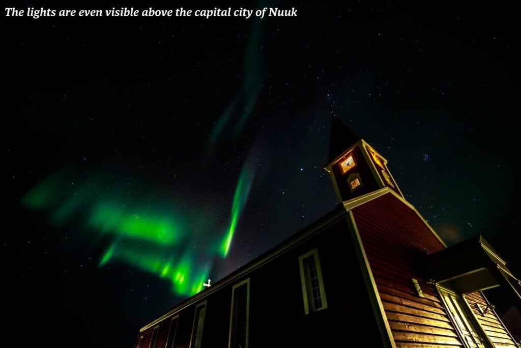 Glimpse of the northern lights above a building in Nuuk, Greenland 