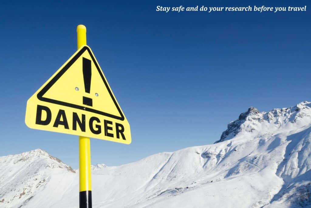 Yellow danger sign at the bottom of a snowy mountain in Europe - unusual travel rules